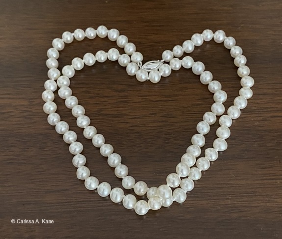 Heart shape made out of a pearl necklace