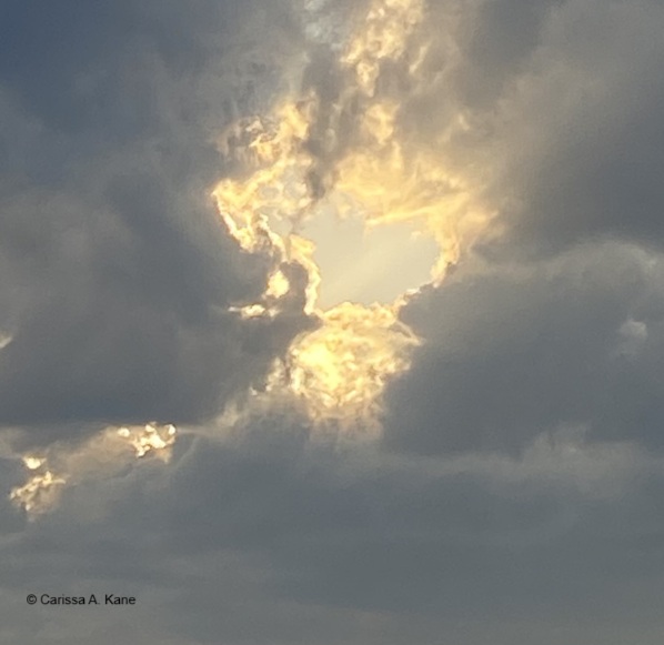 Heart shape opening in the clouds
